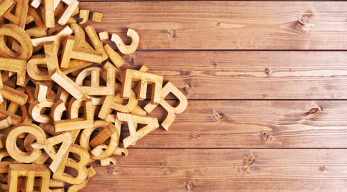 Wooded letters and numbers on a table