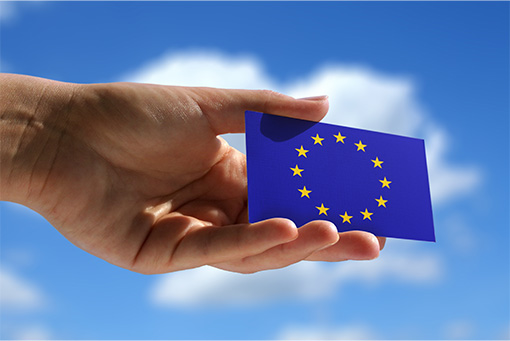 Holding small flag of European Union.