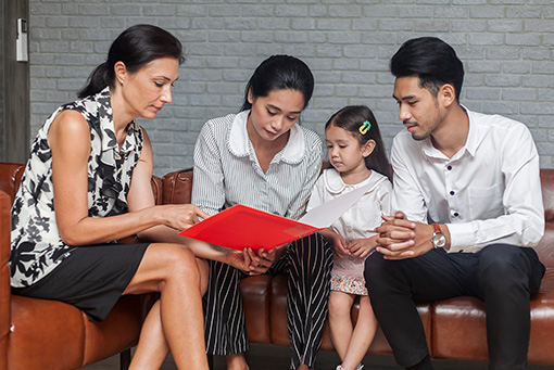 Expat Parents Discussing School Options With a Teacher for Their Child’s Education in Paris